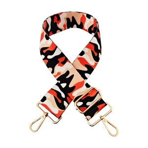 Detail of adjustable camouflage bag strap with orange weaving and gold metal hooks