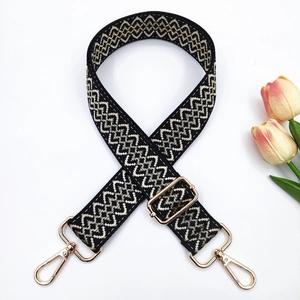 Detail of adjustable 3.8cm wide strap with gold hardware and geometric pattern