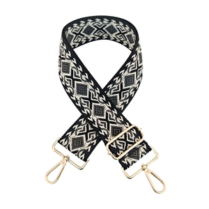 Adjustable geometric ethnic jacquard bag strap with golden hardware on white background