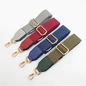 Detailed view of adjustable cotton and PU leather bag straps with gold metal hardware