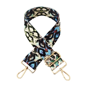 Close-up of animal print woven bag strap with adjustable gold metal buckle and hooks