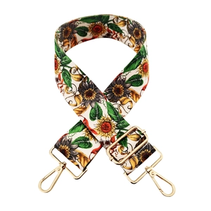 Detail of adjustable floral strap with sunflower pattern and gold metal lobster clasps