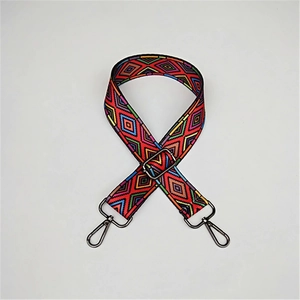 Close-up of ethnic geometric pattern bag strap with dark grey metal rotating hooks