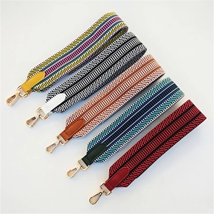Five assorted ethnic style wide woven replacement shoulder straps with gold metal buckles