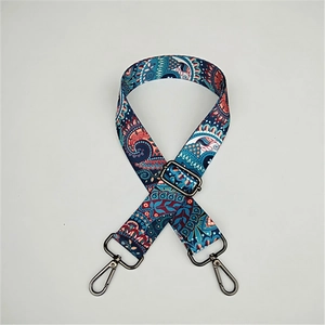 Detail of bohemian style crossbody bag strap with ethnic pattern and metal buckle