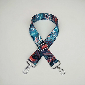 Detail of adjustable paisley wide shoulder strap with silver hooks for crossbody bags