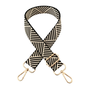 Detail of adjustable black and white geometric twill wide shoulder strap with gold hooks