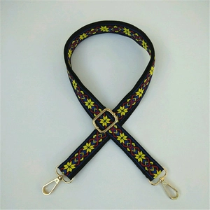 Close-up of ethnic style embroidered replacement strap with golden metal lobster clasps