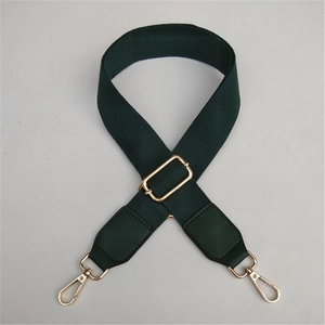 Detail of adjustable forest green canvas bag strap with golden lobster clasps and PU leather