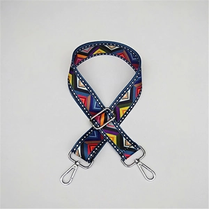 Detail of bohemian style woven bag strap with colorful geometric pattern and silver hooks