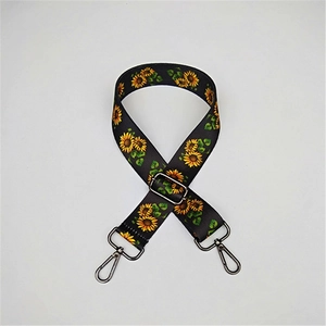Detail of sunflower pattern webbing strap with gunmetal metal hooks for bags