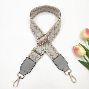 Grey jacquard embroidered wide bag strap with floral pattern and gold metal hardware