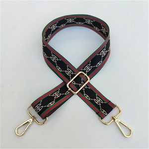 Detail of adjustable wide nylon shoulder strap with classic striped pattern and gold hooks