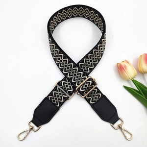 Detail of adjustable 3.8cm jacquard embroidered bag strap with black leather and gold hardware
