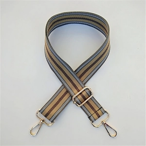 Detail of adjustable wide striped strap with gold lobster clasps for crossbody bags
