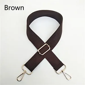 Detailed view of adjustable coffee brown woven strap with golden metal swivel hooks