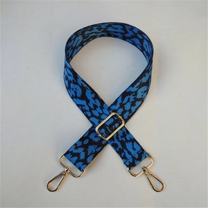 Close-up of leopard print bag strap with durable gold metal swivel hooks and adjuster