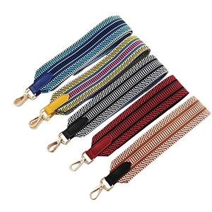 Set of five wide woven crossbody bag straps with colorful patterns and gold lobster clasps