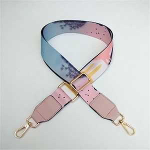 Detail view of adjustable ethnic floral strap with golden metal hooks and pink leather