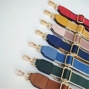 Close-up of adjustable colorful nylon wide shoulder straps with gold metal hooks