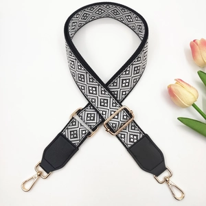 Adjustable wide guitar style bag strap with black and white geometric woven pattern
