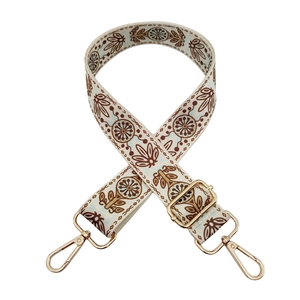 Detail of adjustable bohemian floral woven bag strap with golden metal lobster clasps