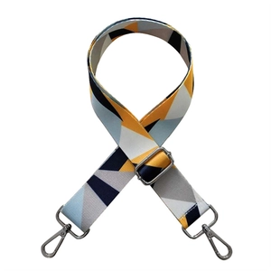 Close-up of adjustable colorful geometric shoulder strap with silver metal swivel hooks