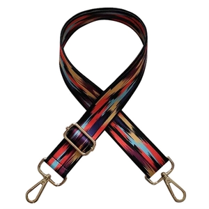 Close-up of bohemian colorful patterned shoulder strap with gold metal lobster clasps