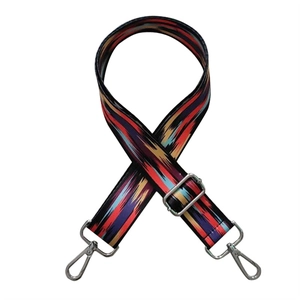 Close-up of adjustable ethnic style wide bag strap with colorful geometric patterns