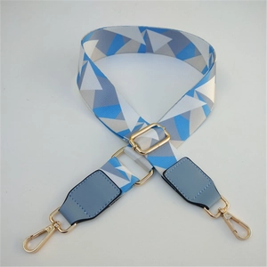 Close-up of geometric patterned replacement bag strap with golden metal lobster clasps