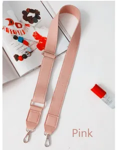 Close-up of pink PU leather adjustable shoulder strap with silver metal hooks and buckle