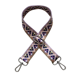 Detail view of ethnic geometric purple wide shoulder strap with silver metal swivel hooks