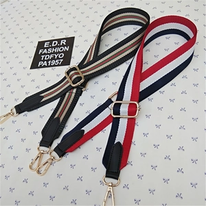 Detail of adjustable nylon straps with gold lobster clasps and leather finishes