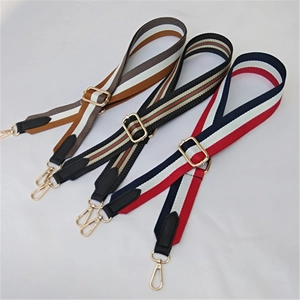 Close-up of adjustable woven bag straps with colorful patterns and gold metal buckles