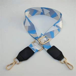 Detail of adjustable geometric triangle shoulder strap with gold metal lobster clasps