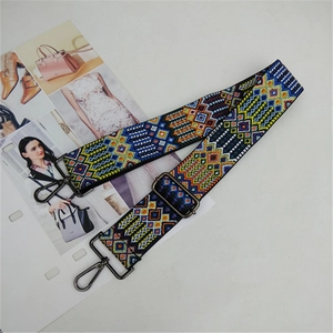 Close-up of geometric ethnic pattern bag strap with vintage bronze metal buckle and adjuster