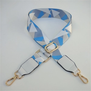 Detail of adjustable geometric strap with gold hooks and white leather ends