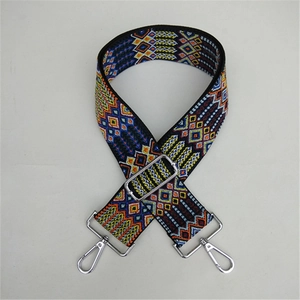 Close-up of retro ethnic geometric pattern wide strap with silver metal swivel hooks