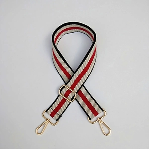 Adjustable woven replacement bag strap with red, black, and beige stripes and gold buckles