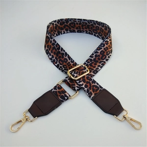 Adjustable leopard print shoulder strap with brown leather ends and gold metal clips