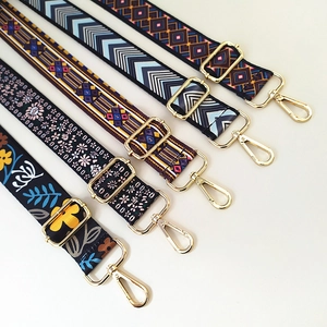 Close-up of five wide ethnic style replacement bag straps with golden swivel hooks