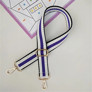 Detail of adjustable purple and white striped bag strap with gold lobster clasps
