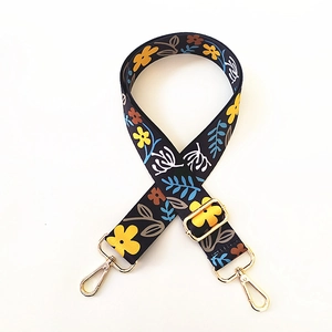 Floral wide shoulder strap for crossbody bags with black base and golden hardware