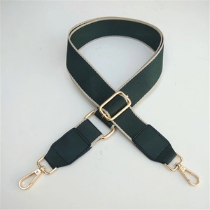 Adjustable dark green fabric shoulder strap with beige trim and golden metal hooks