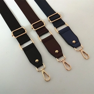 Adjustable wide nylon shoulder straps in black, brown and blue with gold metal hooks