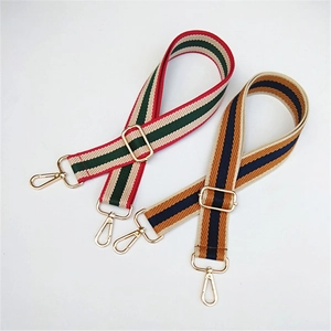 Adjustable striped canvas bag straps with gold metal hooks and colorful webbing texture