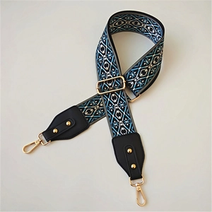 Macro detail of bohemian geometric print strap with gold metal buckle and leather