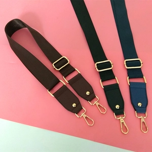 Detail view of adjustable wide fabric replacement straps with golden metal buckles