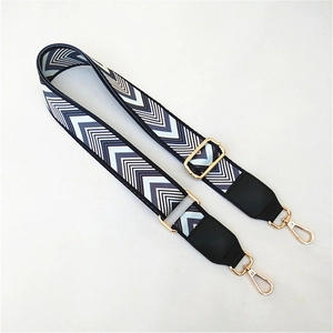 Detail of adjustable chevron patterned strap with gold lobster clasps and black leather ends