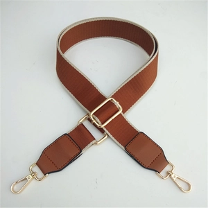 Adjustable brown and beige woven bag strap with golden buckles for crossbody bags